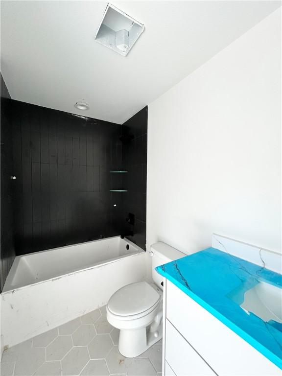 200 NW 9th St, Bentonville, AR 72712 - full bathroom with tile patterned flooring, toilet, shower / washtub combination, and vanity