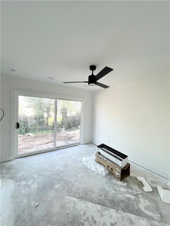 200 NW 9th St, Bentonville, AR 72712 - spare room featuring plenty of natural light, concrete flooring, and ceiling fan