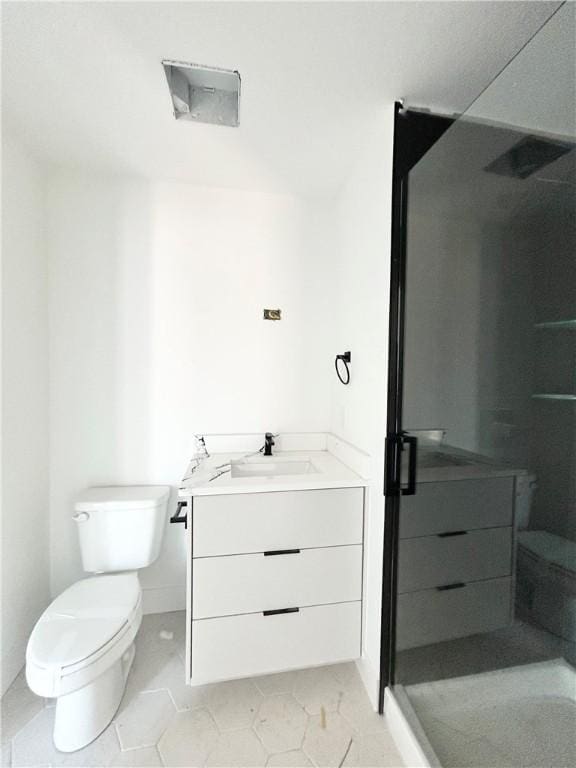 200 NW 9th St, Bentonville, AR 72712 - full bathroom featuring vanity, toilet, a shower stall, and tile patterned flooring