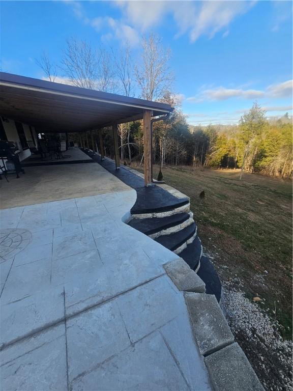 exterior space with a lawn and a carport