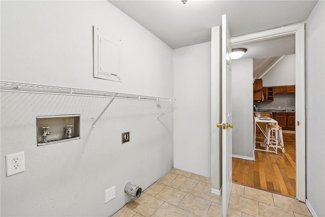 clothes washing area featuring hookup for an electric dryer, light tile patterned floors, and washer hookup