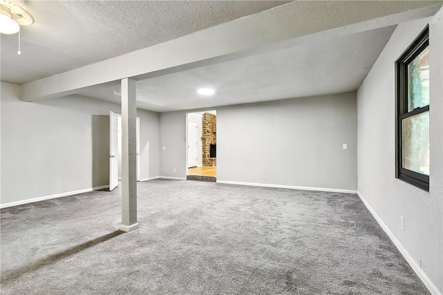 basement featuring carpet floors and a textured ceiling