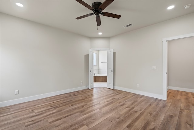 unfurnished bedroom featuring ensuite bathroom, ceiling fan, and light hardwood / wood-style flooring