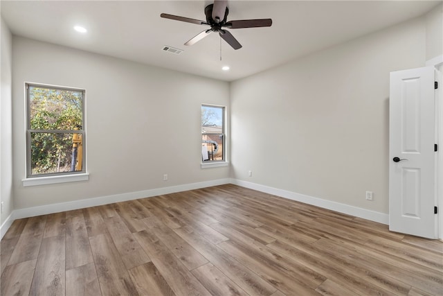 spare room with light hardwood / wood-style floors and ceiling fan