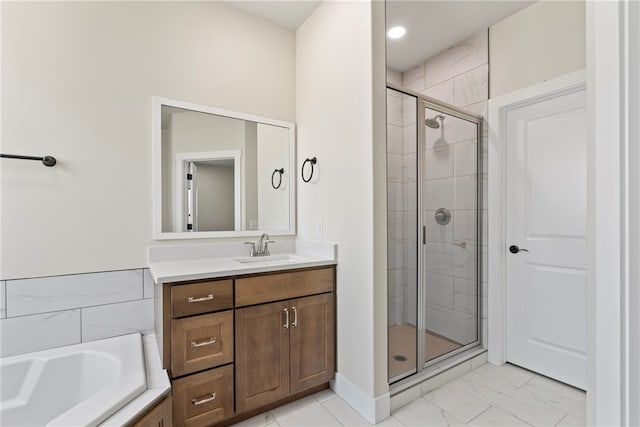 bathroom with vanity and separate shower and tub