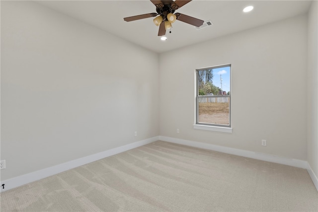 empty room featuring ceiling fan and light colored carpet