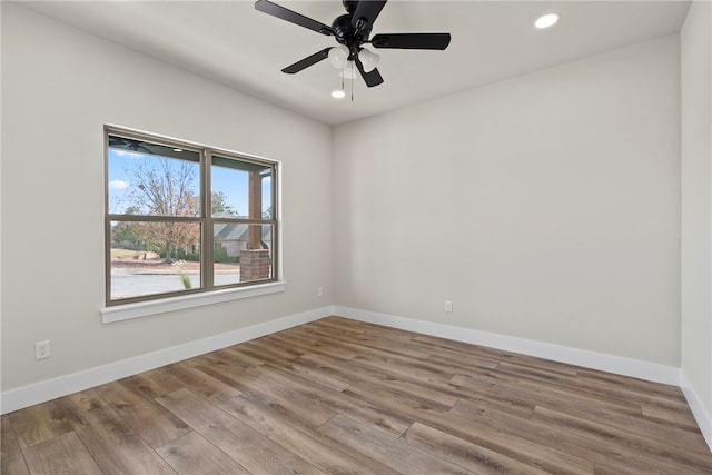 unfurnished room with light wood-type flooring and ceiling fan