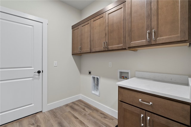 washroom with cabinets, hookup for a washing machine, light hardwood / wood-style flooring, and electric dryer hookup