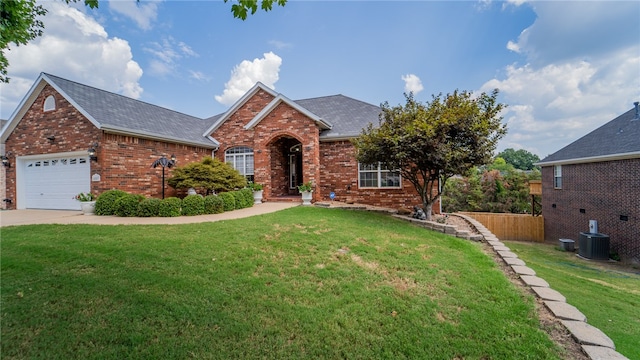 view of front facade with an attached garage, central AC, brick siding, concrete driveway, and a front lawn