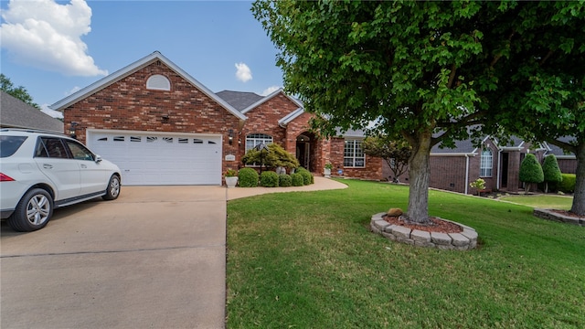 view of front property featuring a garage and a front yard