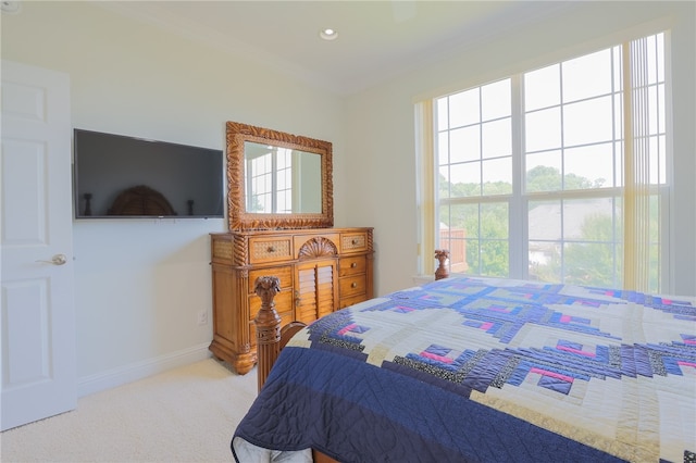 carpeted bedroom featuring crown molding