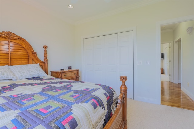 carpeted bedroom featuring a closet and crown molding