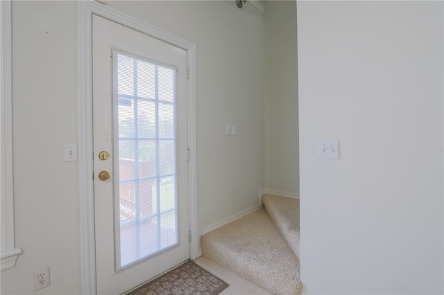 doorway to outside with light colored carpet