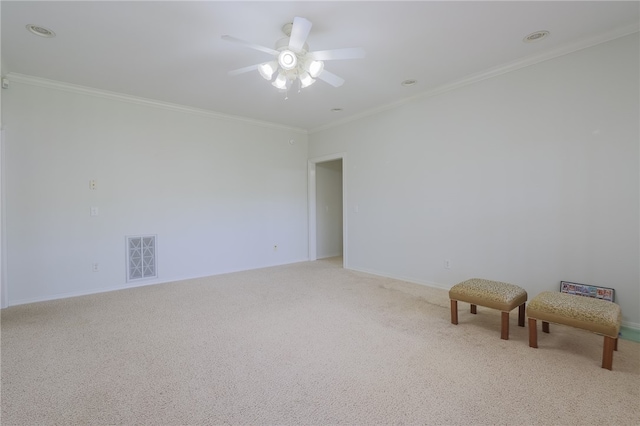 carpeted empty room featuring ceiling fan and crown molding