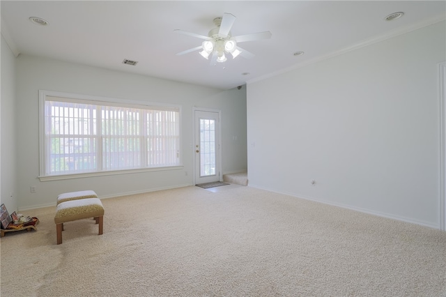 unfurnished room featuring a wealth of natural light, light colored carpet, and ceiling fan