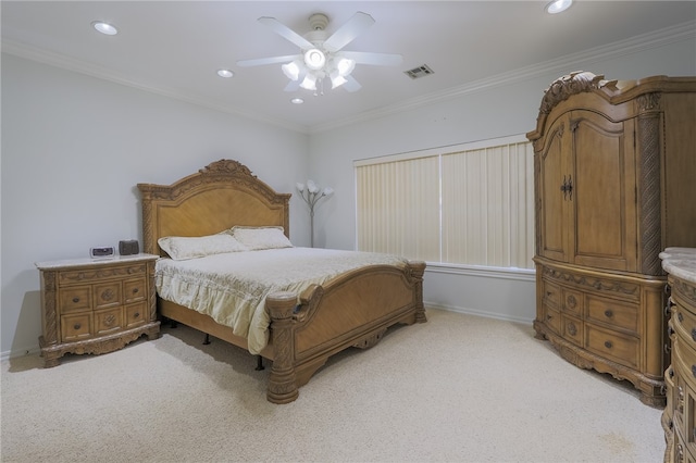 carpeted bedroom with ornamental molding and ceiling fan