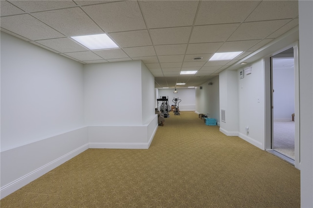 interior space with carpet floors and a drop ceiling