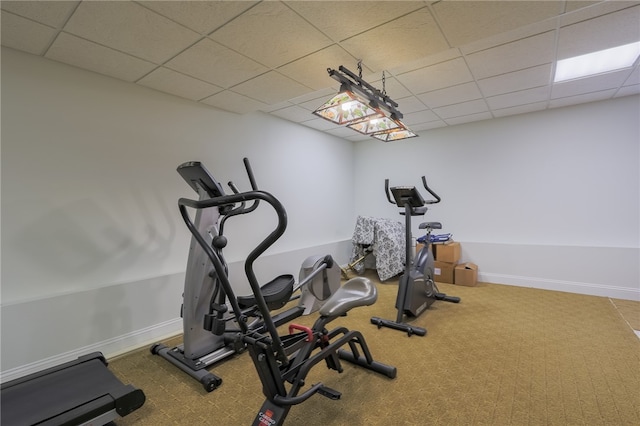 exercise area with carpet floors and a drop ceiling