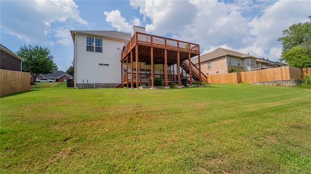 back of house with a lawn and a wooden deck