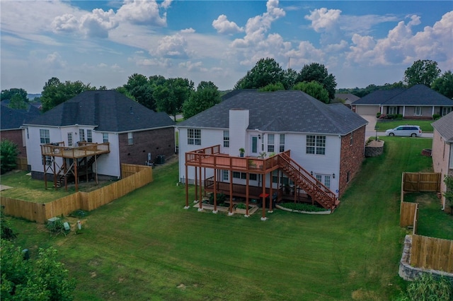 rear view of property with a yard and a deck