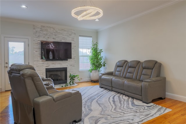 living room with a healthy amount of sunlight, ornamental molding, and hardwood / wood-style flooring