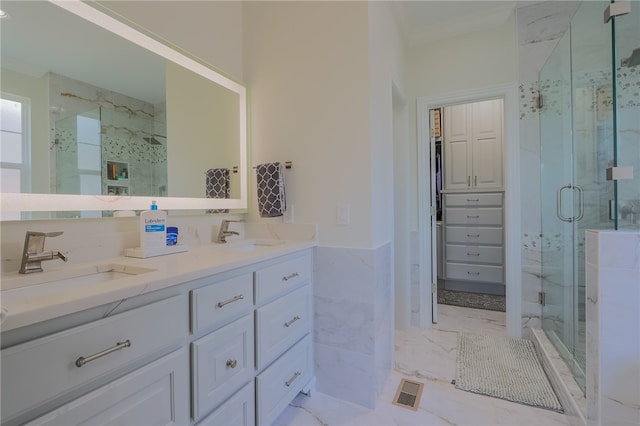 bathroom featuring ornamental molding, an enclosed shower, and vanity