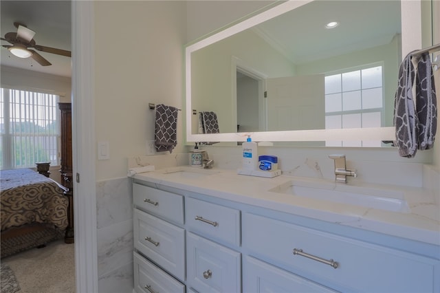 bathroom featuring ceiling fan, vanity, tile walls, and ornamental molding