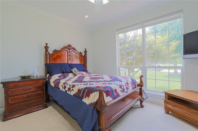 bedroom with crown molding, ceiling fan, and carpet floors