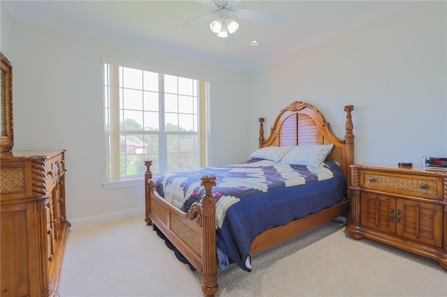 bedroom with ceiling fan and light carpet