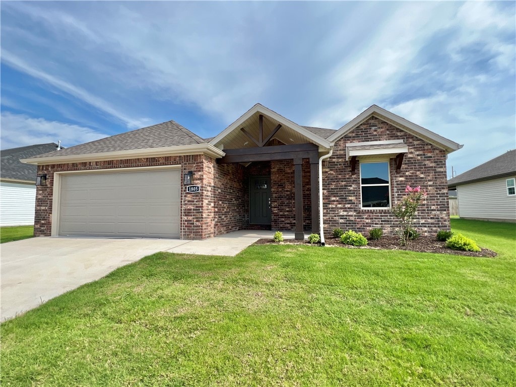 ranch-style home featuring a garage and a front lawn