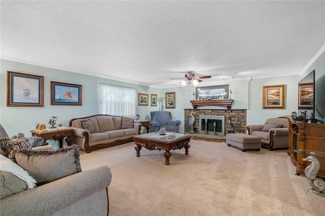 living area with carpet, a textured ceiling, and a stone fireplace