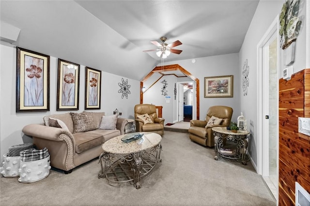 carpeted living area featuring visible vents, vaulted ceiling, and ceiling fan