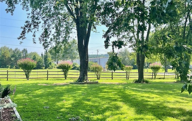 view of yard featuring a rural view and fence