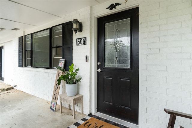 doorway to property featuring a porch