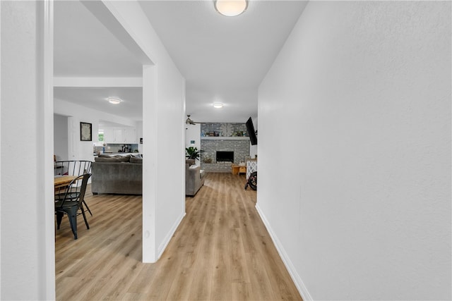 hallway with light hardwood / wood-style flooring