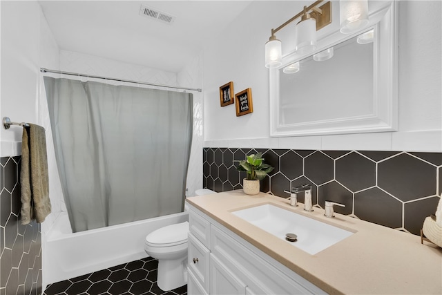 full bathroom featuring tile patterned floors, toilet, shower / tub combo with curtain, tasteful backsplash, and vanity