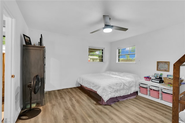 bedroom with light hardwood / wood-style flooring and ceiling fan