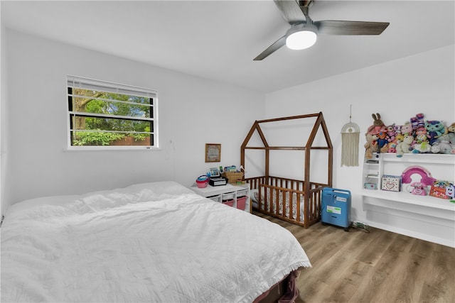 bedroom with wood-type flooring and ceiling fan