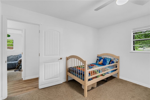 bedroom with ceiling fan and hardwood / wood-style floors