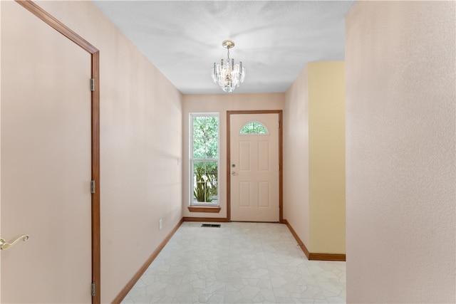 entryway featuring an inviting chandelier