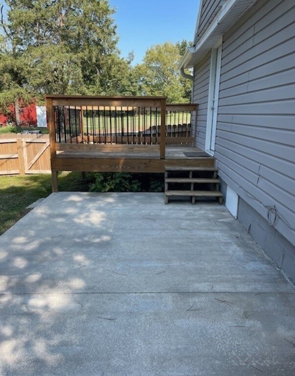 wooden terrace featuring a patio and fence