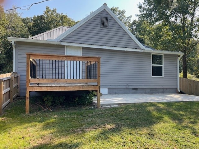 back of house with a deck, a patio, fence, a yard, and crawl space