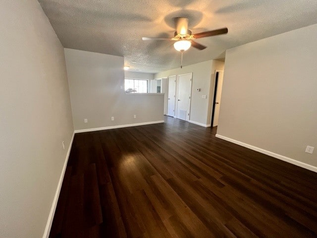 interior space featuring a textured ceiling, ceiling fan, and dark hardwood / wood-style floors