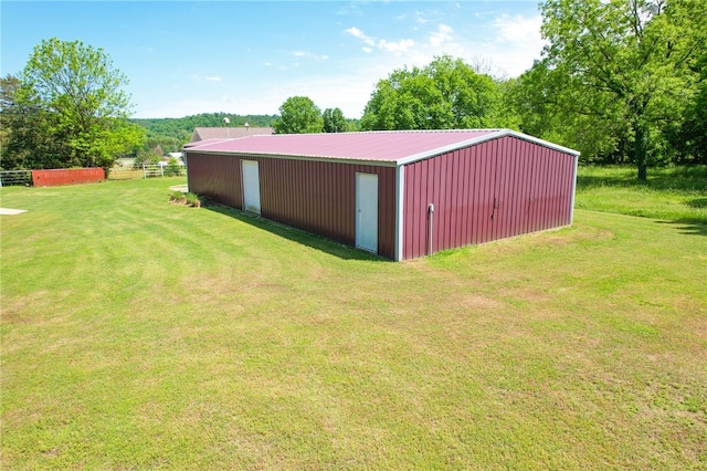 view of outbuilding with a yard