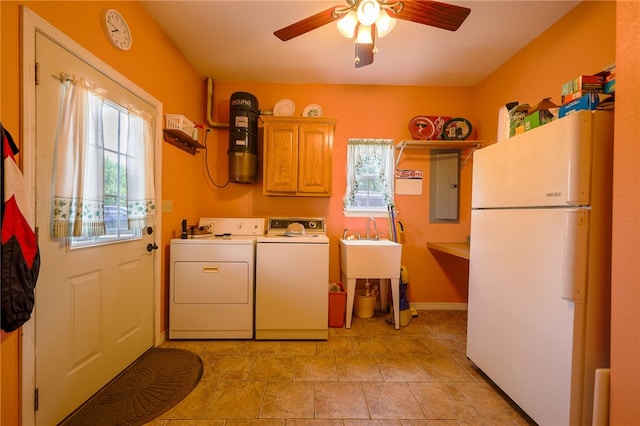 washroom featuring ceiling fan, electric panel, plenty of natural light, and washing machine and dryer