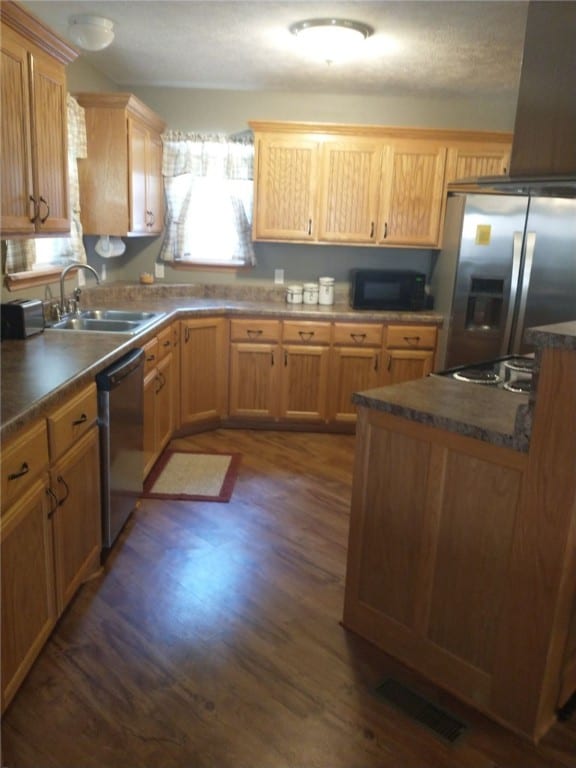 kitchen featuring island range hood, sink, appliances with stainless steel finishes, and dark hardwood / wood-style flooring