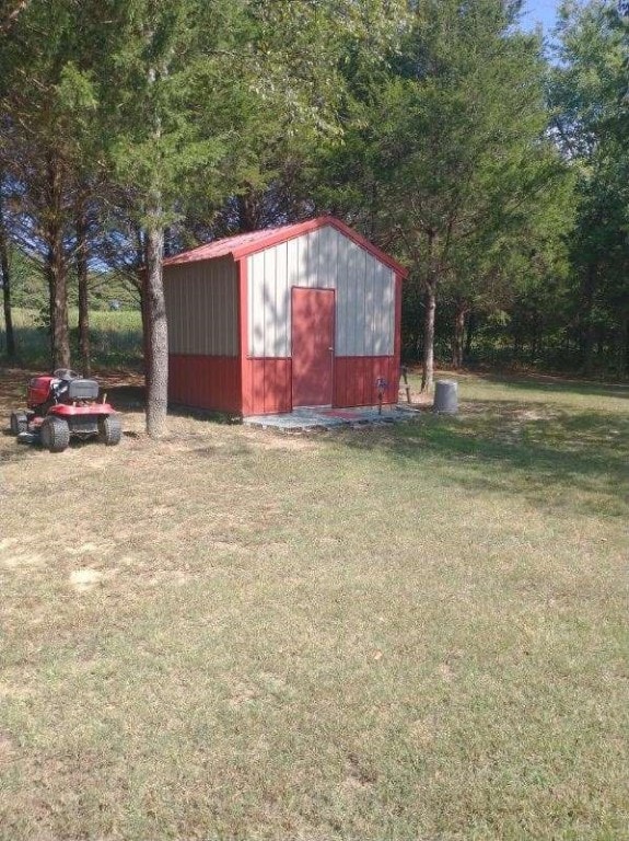 view of outdoor structure with a lawn