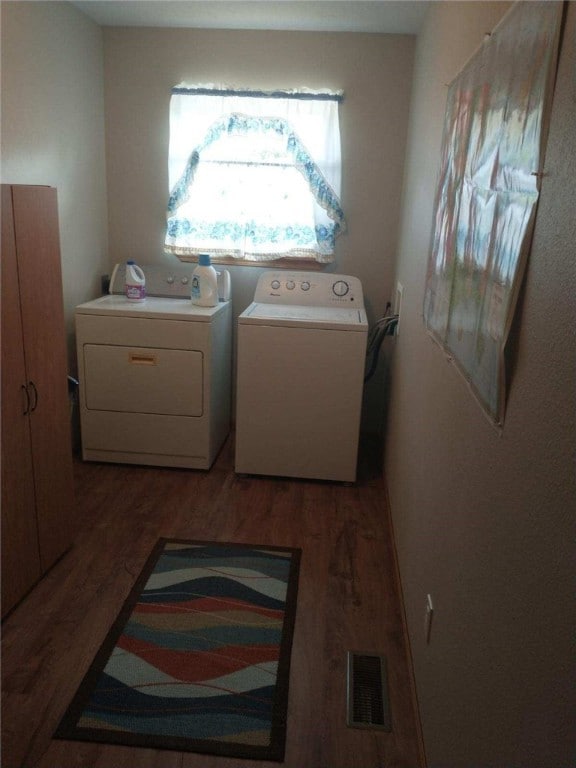 laundry area with light wood-type flooring and washer and clothes dryer