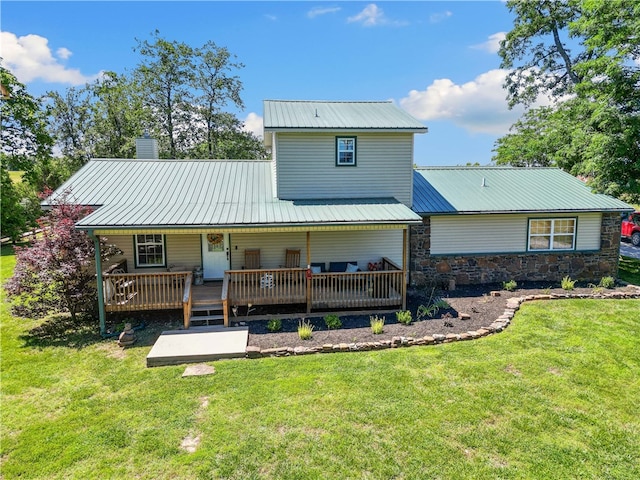 back of house featuring a wooden deck and a yard