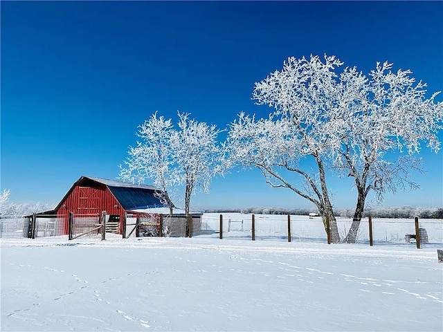 yard layered in snow featuring an outdoor structure